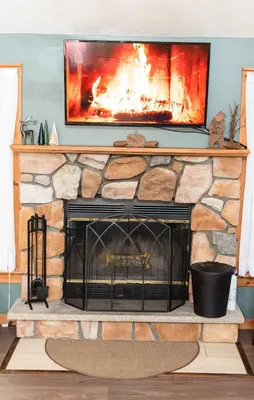a fireplace with a tv on top of it at Camelback Private Home located behind Waterpark & Ski Lift in Tannersville