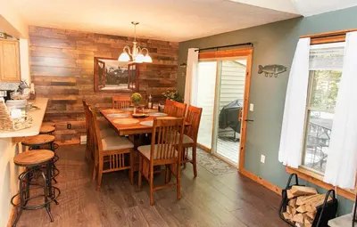 a dining room with a wooden table and chairs at Camelback Private Home located behind Waterpark & Ski Lift in Tannersville