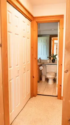 a bathroom with a toilet and a sink and a door at Camelback Private Home located behind Waterpark & Ski Lift in Tannersville