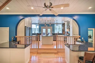 a kitchen with blue walls and a ceiling fan at 16 Mi to Camelback Resort Getaway with Game Room in Saylorsburg