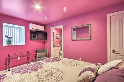 a bedroom with pink walls and a bed at 16 Mi to Camelback Resort Getaway with Game Room in Saylorsburg