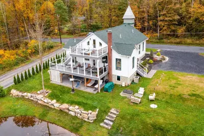 an aerial view of a house with chairs on the lawn at 16 Mi to Camelback Resort Getaway with Game Room in Saylorsburg