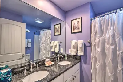 a purple bathroom with two sinks and a mirror at 16 Mi to Camelback Resort Getaway with Game Room in Saylorsburg