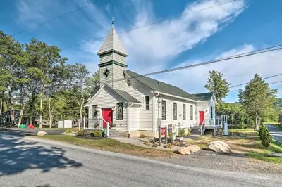 a white church with a steeple on a street at 16 Mi to Camelback Resort Getaway with Game Room in Saylorsburg