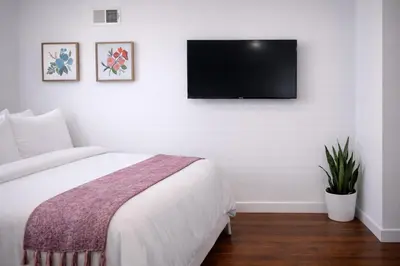a bedroom with a bed and a flat screen tv on the wall at Artsy Hidden Gem -- FREE PARKING in Philadelphia