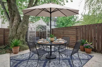 a table and chairs with an umbrella on a patio at Artsy Hidden Gem -- FREE PARKING in Philadelphia