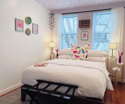 a bedroom with a large bed with white sheets and pillows at Artsy Hidden Gem --- FREE PARKING in Philadelphia