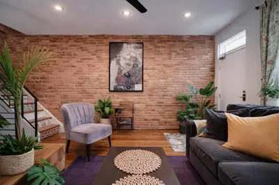 a living room with a brick wall at Artsy Hidden Gem --- FREE PARKING in Philadelphia