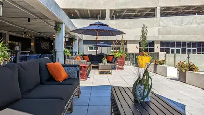 an outdoor patio with couches and an umbrella at Holiday Inn Lancaster by IHG in Lancaster