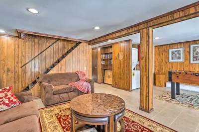 a living room with a couch and a table at Excellent Lakeview Getaway with Watercrafts Included in Pocono Lake