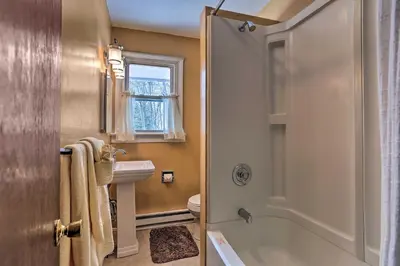 a bathroom with a tub and a toilet and a sink at Excellent Lakeview Getaway with Watercrafts Included in Pocono Lake