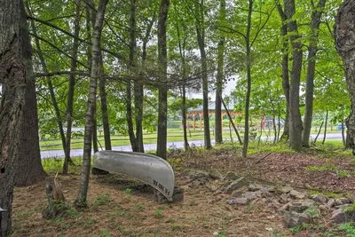 a metal object in the middle of a park with trees at Excellent Lakeview Getaway with Watercrafts Included in Pocono Lake