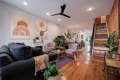 a living room with a couch and a fireplace at Artsy Hidden Gem - FREE PARKING in Philadelphia