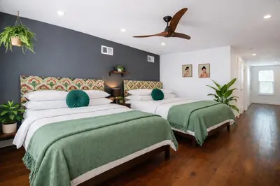 a bedroom with two beds with green blankets at Artsy Hidden Gem - FREE PARKING in Philadelphia