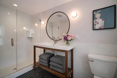 a bathroom with a sink and a mirror and a toilet at Artsy Hidden Gem - FREE PARKING in Philadelphia