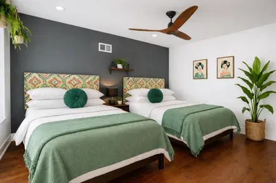 a bedroom with two beds and a ceiling fan at Artsy Hidden Gem - FREE PARKING in Philadelphia