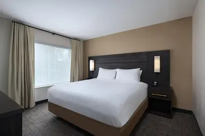 a bedroom with a large bed and a window at Residence Inn New Brunswick Tower Center Blvd. in East Brunswick