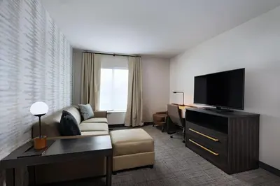 a living room with a couch and a flat screen tv at Residence Inn New Brunswick Tower Center Blvd. in East Brunswick