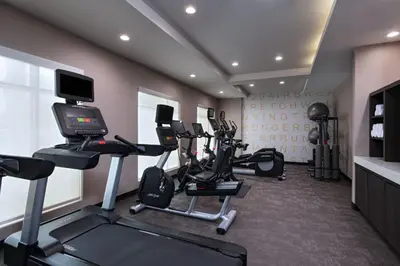 a fitness room with tread machines and a television at Residence Inn New Brunswick Tower Center Blvd. in East Brunswick