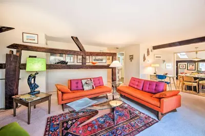 a living room with two orange couches and a table at Creek Access and Deck Runningwater Lancaster Gem in Lancaster
