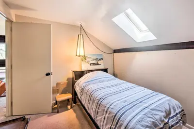 a bedroom with a bed and a skylight at Creek Access and Deck Runningwater Lancaster Gem in Lancaster