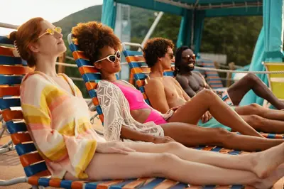 a group of people sitting in beach chairs on a boat at Camelback Resort in Tannersville