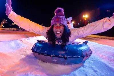a woman is laying in an inflatable at Camelback Resort in Tannersville