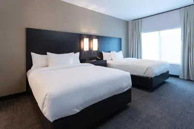 a hotel room with two beds and a window at Residence Inn by Marriott Wilkes-Barre Arena in Wilkes-Barre