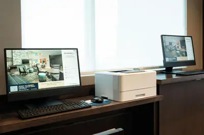 a desk with a computer monitor and a printer at Residence Inn by Marriott Wilkes-Barre Arena in Wilkes-Barre