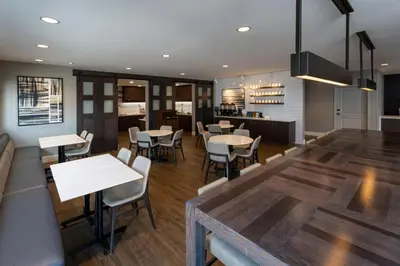 a dining room and kitchen with tables and chairs at Residence Inn by Marriott Wilkes-Barre Arena in Wilkes-Barre