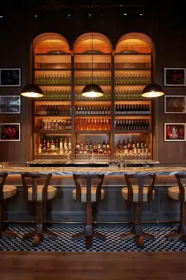 a bar with a lot of bottles of alcohol at CIVILIAN Hotel in New York