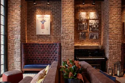 a living room with a couch and a fireplace at CIVILIAN Hotel in New York