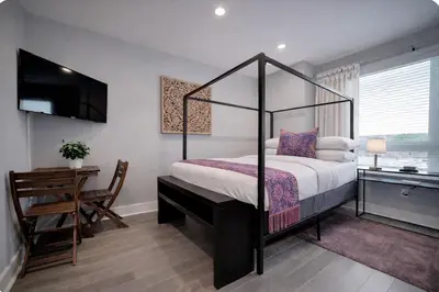 a bedroom with a canopy bed and a desk at Artsy Hidden Gem ll -Free Parking -- in Philadelphia