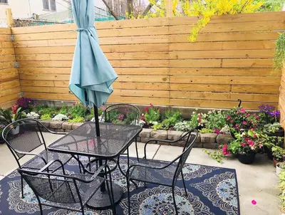 a table and chairs with an umbrella on a patio at Artsy Hidden Gem ll -Free Parking -- in Philadelphia