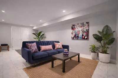 a blue couch in a living room with plants at Artsy Hidden Gem ll -Free Parking -- in Philadelphia