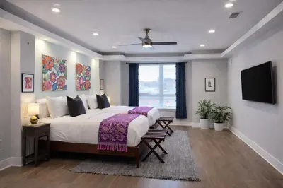 a bedroom with a large bed and a flat screen tv at Artsy Hidden Gem ll -Free Parking --- in Philadelphia