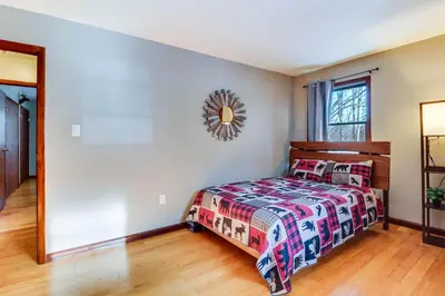 a bedroom with a bed and a mirror at Lake Access and Private Hot Tub at Poconos Home! in White Haven