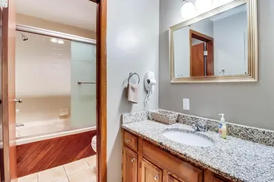 a bathroom with a sink and a shower and a mirror at Lake Access and Private Hot Tub at Poconos Home! in White Haven
