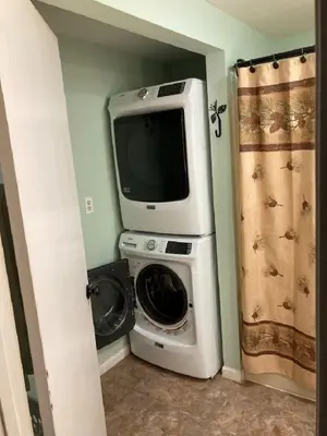 a tv sitting on top of a washing machine in a room at Black Bear Lodge @ Middle Creek in Stevens