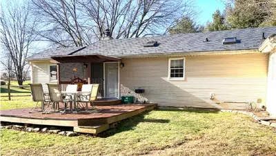 a house with a table and chairs on a deck at Black Bear Lodge @ Middle Creek in Stevens