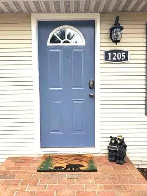 a blue door on a house with a sign on it at Black Bear Lodge @ Middle Creek in Stevens