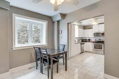 a kitchen with a dining room table and chairs at 8 Mi to Liberty Bell! Spacious and Charming Home in Upper Darby