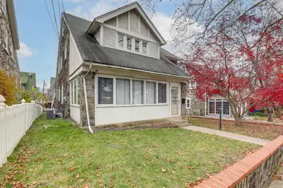 a house with a fence in front of it at 8 Mi to Liberty Bell! Spacious and Charming Home in Upper Darby