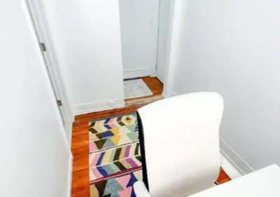 a hallway with a door and a rug in a room at Legacy - Spring Garden University City in Philadelphia