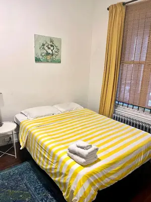 a yellow and white striped bed in a room at Legacy - Spring Garden University City in Philadelphia