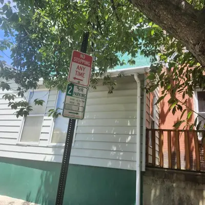 a no parking sign in front of a house at Oui on Ludlow - Entire House and Private Rooms in University City in Philadelphia