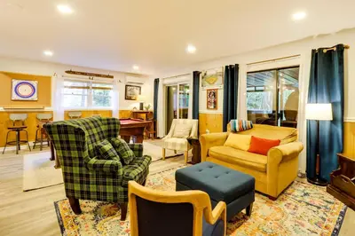 a living room with two chairs and a couch at 3 Mi to Slopes! Poconos Chalet with Hot Tub and Sauna in Lake Harmony