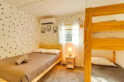 a bedroom with two bunk beds and a window at 3 Mi to Slopes! Poconos Chalet with Hot Tub and Sauna in Lake Harmony