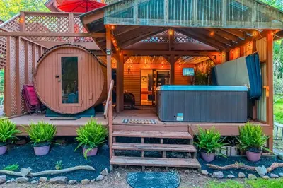 a large house with a large deck with a gazebo at 3 Mi to Slopes! Poconos Chalet with Hot Tub and Sauna in Lake Harmony