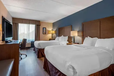 a hotel room with two beds and a flat screen tv at Comfort Inn Horsham - Philadelphia in Horsham